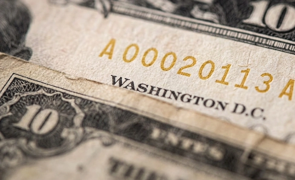 Macro image of overlapping dollar bills focusing on one element